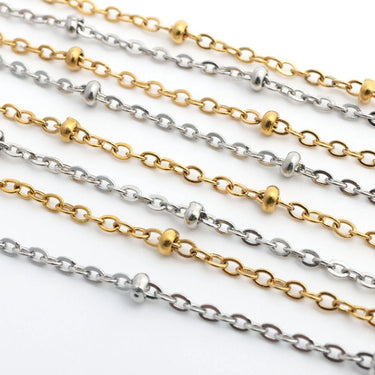 Gold and silver Satellite Belly Chains on a white background