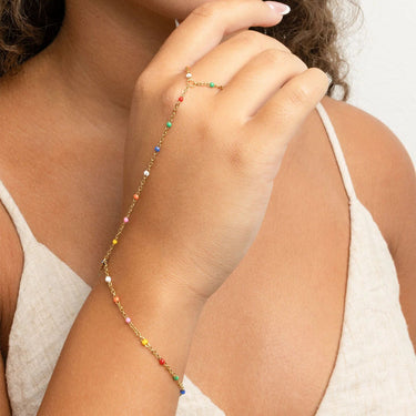 Close-up of a person a silver Multi Color Hand Chain on a light background