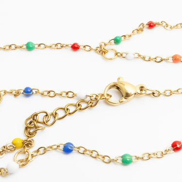Gold Multi Color Hand Chain with colorful beads on a white background