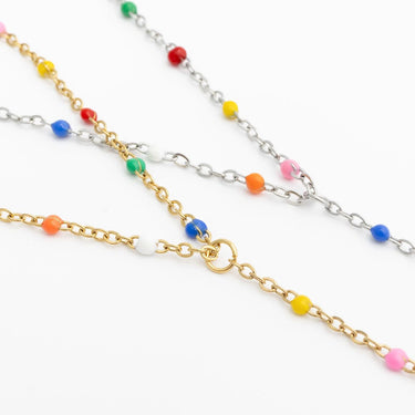 Two gold and silver Multi Color Hand Chains on a white background