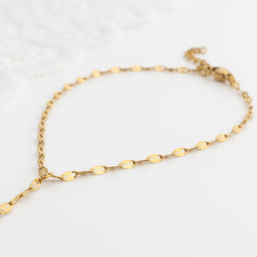 Gold Lip Hand Chain on a light gray background