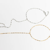 Two gold and silver Lip Hand Chain on a white background