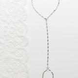 Silver  Lip Hand Chain on a textured white background