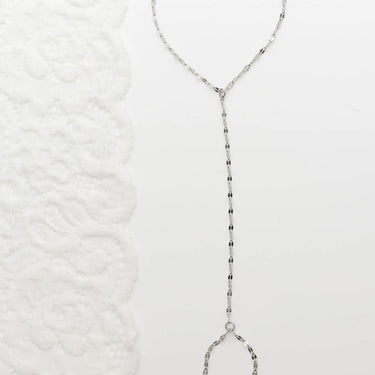 Silver  Lip Hand Chain on a textured white background