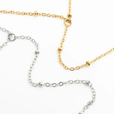 Gold and silver Satellite Hand Chains on a white background