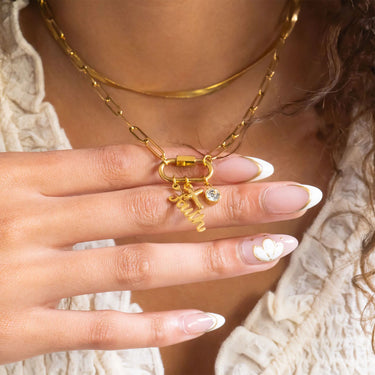 Close-up of a hand wearing gold jewelry with a blurred background