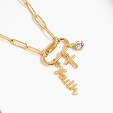 Gold necklace with charms on a white background