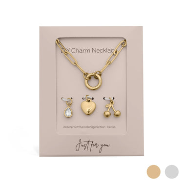 Gold charm necklace set with three charms on a 'Just for you' card.