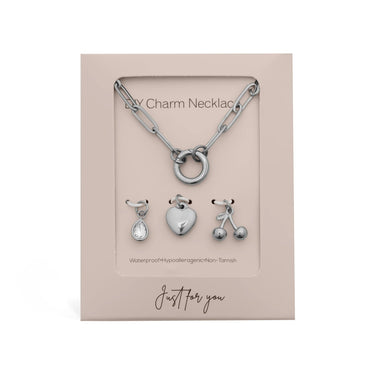 Silver charm necklace with three pendants on a display card.