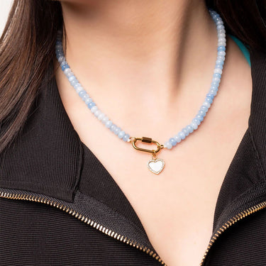 Necklace with a heart-shaped pendant worn by a person