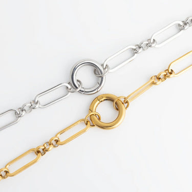 Two gold and silver chain bracelets on a white background