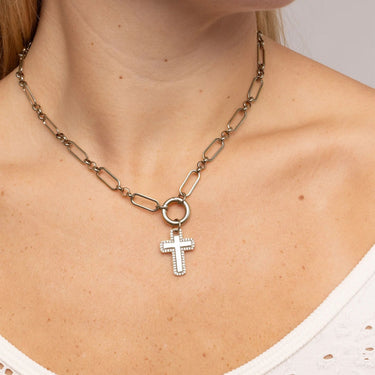 Necklace with a cross pendant worn by a person