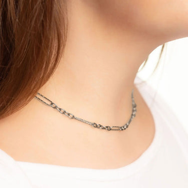 Necklace worn by a person on a plain background