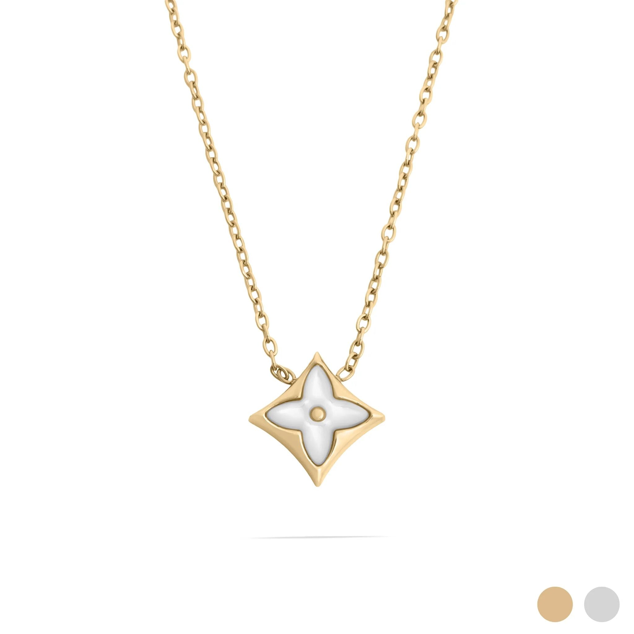 Gold necklace with a star-shaped pendant on a white background