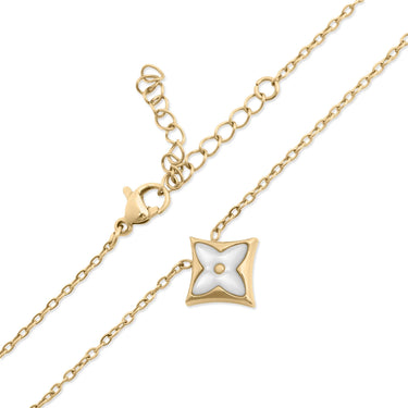 Gold necklace with a white star-shaped pendant on a white background