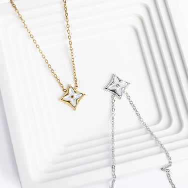 Gold and silver star-shaped necklaces on a white background