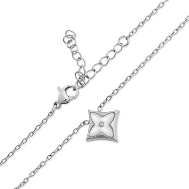 Silver necklace with a star-shaped pendant on a white background