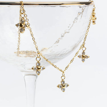Gold necklace with butterfly pendants on a white background