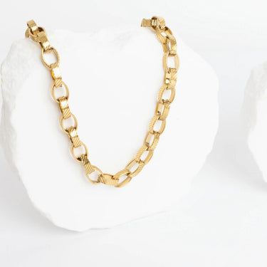 Gold chain bracelet on a white background