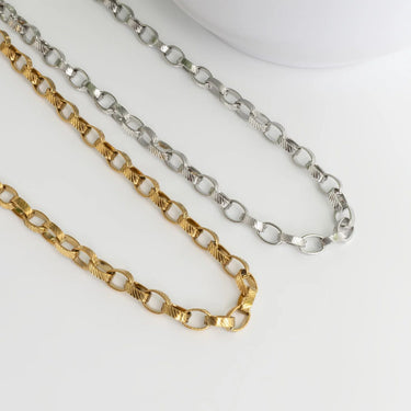 Two gold and silver chain necklaces on a white background