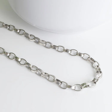 Silver chain necklace on a white background