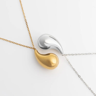 Two-tone Tear Drop Charm Necklaces on a gold chain against a white background