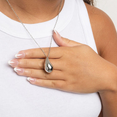 Silver teardrop pendant necklace on a white background