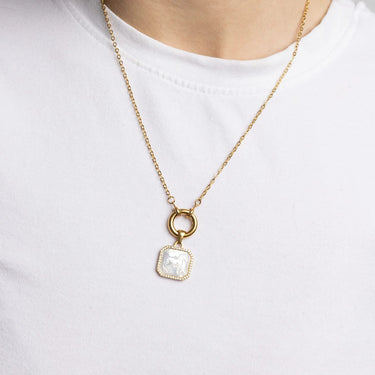 Gold necklace with a pendant on a white background