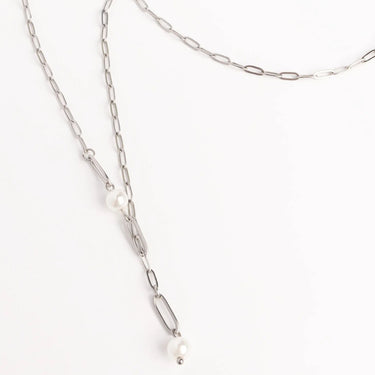 Silver chain necklace with pearls on a white background