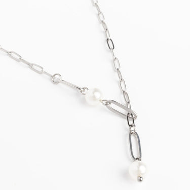 Silver chain necklace with pearls on a white background