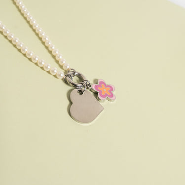 Polished Heart Pendant with flower charm on pearl necklace