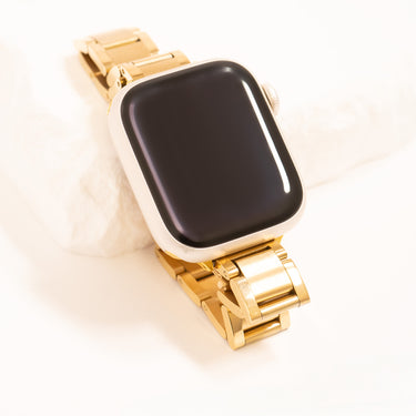 Smartwatch with a gold band on a white background