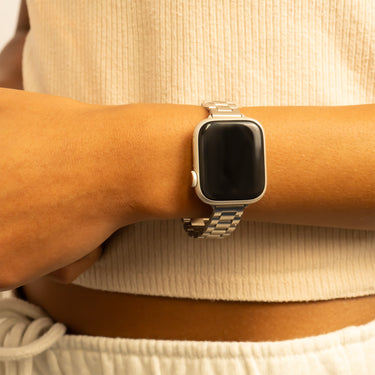 Smartwatch on a wrist with a neutral background