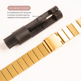 Gold watch band with link adjuster on a white background