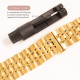 Gold watch band with black link adjuster on a white background
