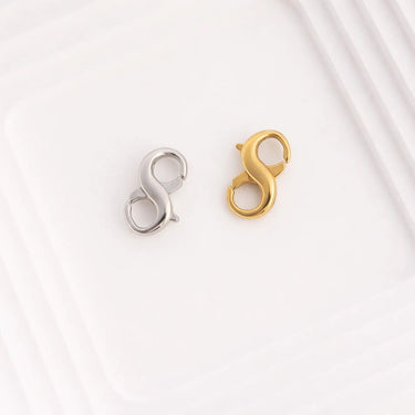 Gold and silver clasp connectors on a light gray background