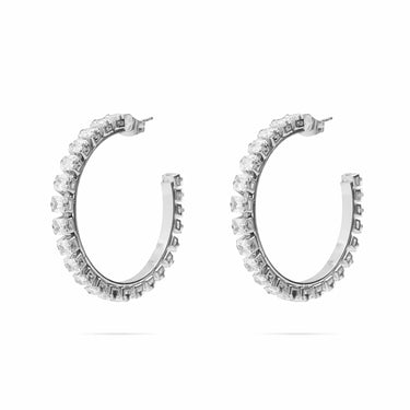 Pair of silver hoop earrings with clear gemstones on a white background