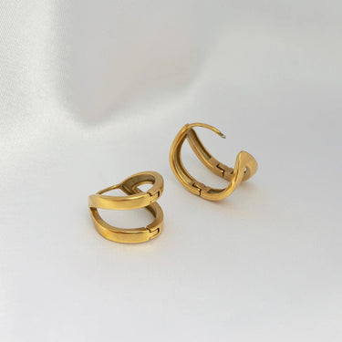 Pair of gold hoop earrings on a white background