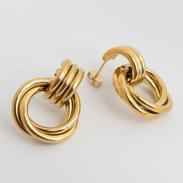 Pair of gold hoop earrings on a light gray background