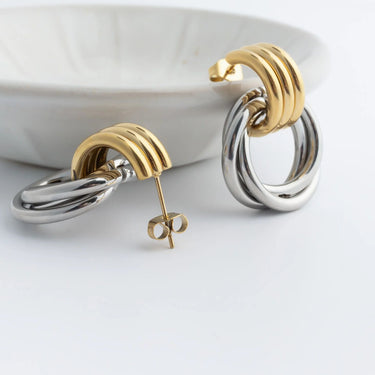 Gold and silver hoop earrings on a white background