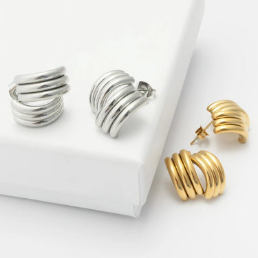 Silver and gold hoop earrings on a white background