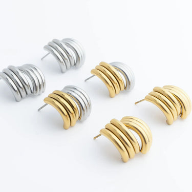 Gold and silver hoop earrings on a white background