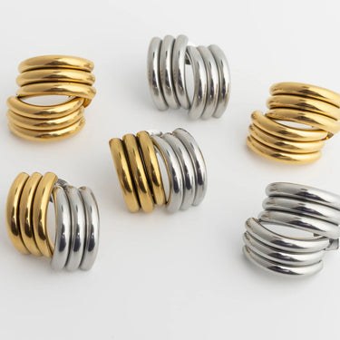 Gold and silver spiral ring set on a white background