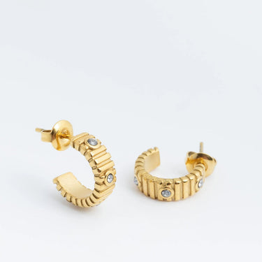 Gold hoop Fluted Huggie with Stones Earrings with small stones on a white background