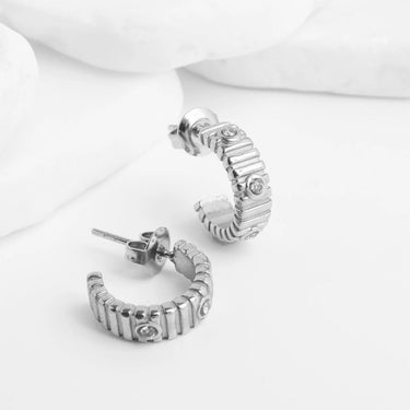 Silver hoop Fluted Huggie with Stones Earrings with embedded stones on a white background