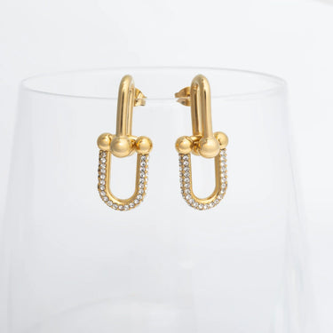 Gold hoop earrings with small diamonds on a white background