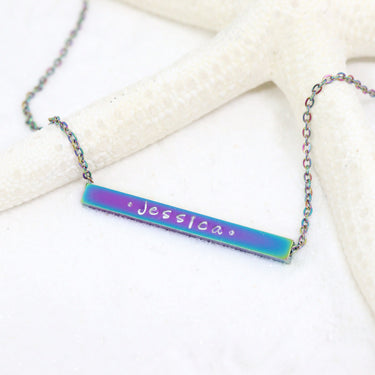 Life style photo with custom engraved chain necklace with bar pendant, the name "Jessica" inscribed on the pendant