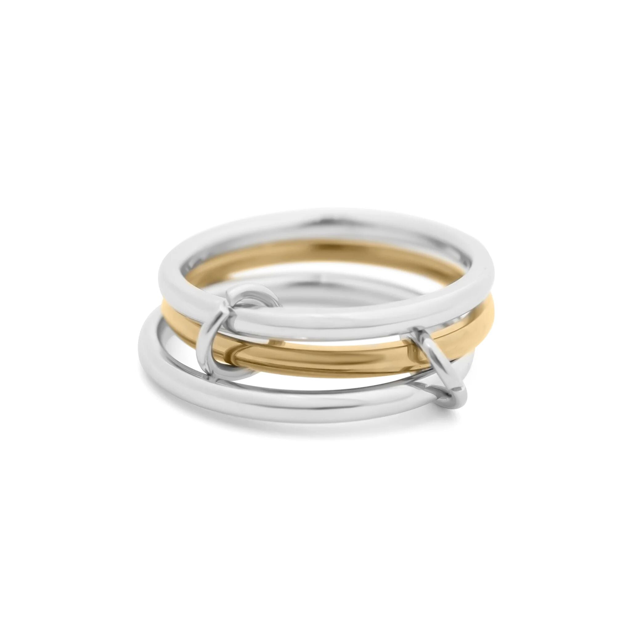 Three interlocking rings, two silver and one gold, on a white background