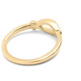 Gold ring with a bow design on a white background