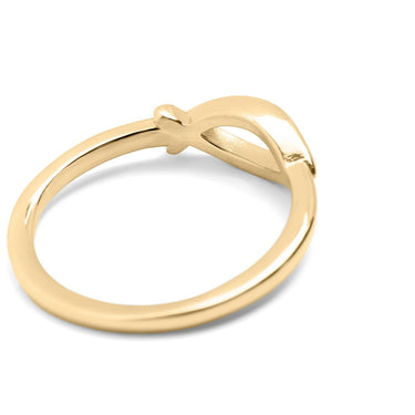 Gold ring with a bow design on a white background